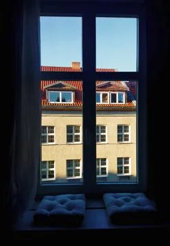 Large window with pillows on a wide windowsill. Stock Photos