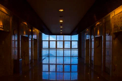 Large window with reflection during the morning and people in frame. Stock Photos