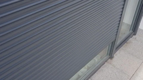 Large window with roller shutter opening on house exterior Stock Footage 334673678