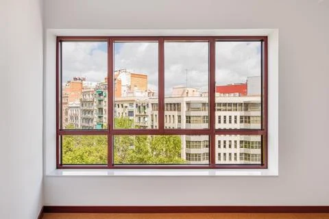 Large window in the room with a wide window sill. Window in plastic brown frame Stock Photos