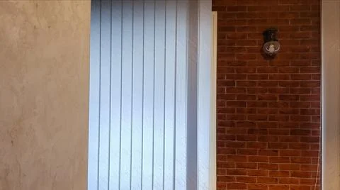 Large window with vertical white or gray blinds, loft, brick wall, industrial Stock-Fotos