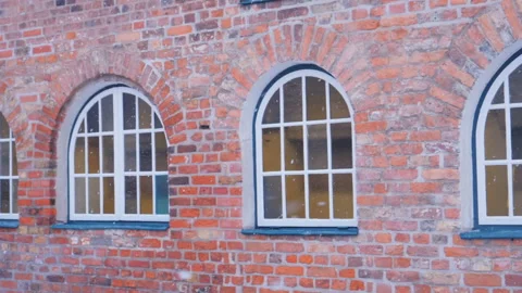 Large windows on old brick house facade. Winter time Stockbeeldmateriaal 96180361