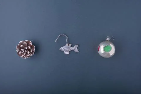 A large winter cone, an old silver fish Christmas tree toy, a Christmas ball  写真素材