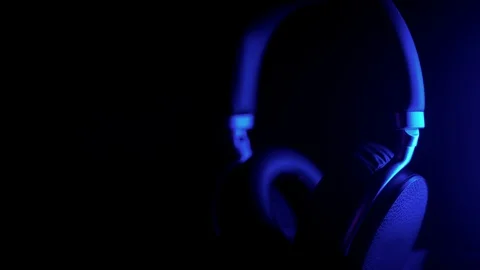 Large wireless studio headphones with blue dynamic light Stock Footage 128123749