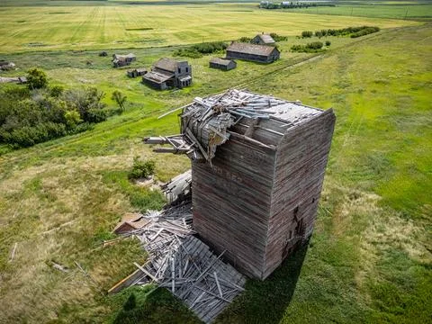 Large wooden grain elevator is in the middle of a field Stock Photos