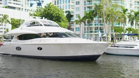 Large yacht navigating from left to right on camera in a canal in fort laud.. Stock Footage 249874536