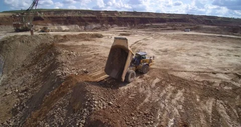 Large yellow and black empty quarry dump truck drives Stock Footage 130194967