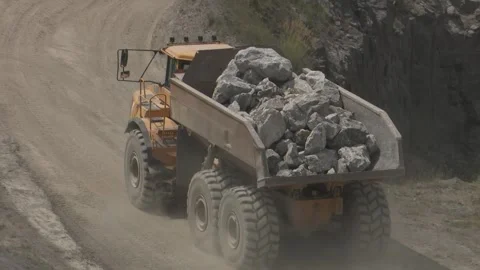 Large yellow articulated dump truck transporting heavy rocks a heavy duty Stock Footage 340264488