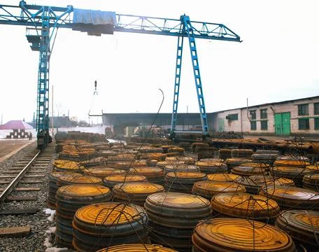 Large yellow circular construction materials are stacked and organized in an Stock Photos