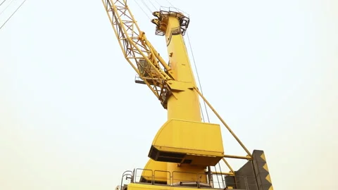 Large yellow crane operates in construction area during daytime Stock Footage 318197252
