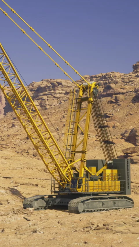 A large yellow crane is set up at a construction site in a desert area Stock Footage 331708154