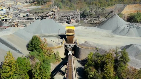 Large Yellow Dump Truck Emptying Aggregate Into Quarry Hopper Stock Footage 331836696