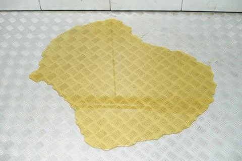 Large yellow puddle of liquid or urine on the floor in the elevator Stock Photos