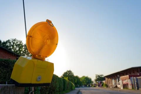 Large yellow roadside box with reflective marker for night visibility. Stock Photos