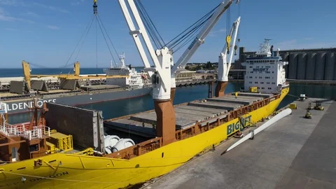 Large yellow ship unloading wind blades at Portland Victoria, Australia Stock Footage 93278415