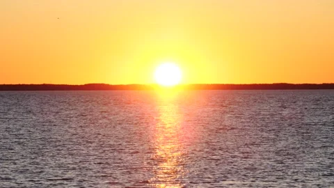 Large yellow sunset bright in the sky at bay and ocean Video stock 150198104