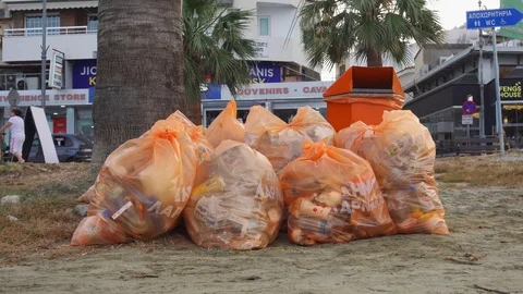 LARNACA, CYPRUS - CIRCA May 2019: Garbage can with garbage bags full of leftover Stock Footage 115357391