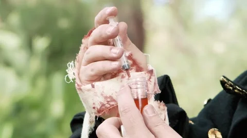 LARP (live action role play) scene: a doctor picking a liquid from a Stock Footage 265947509