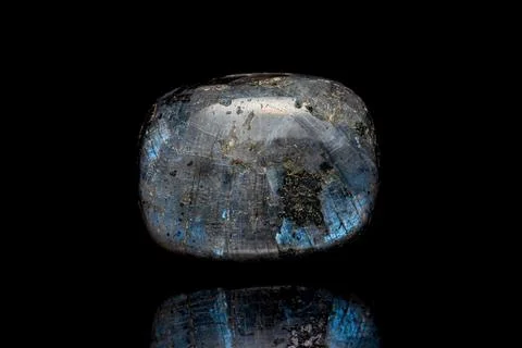 Larvikite stone on dark background Photos