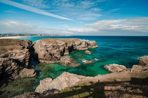 Las catedrales beach exploring rugged cliffs and clear turquoise ocean Stock Photos