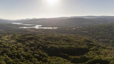 Las Conchas dam with expansive forest landscape in Galicia Stock Photos