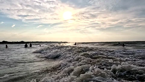 Las Penas, Ecuador: 3-11-2022: People swimming in the ocean Stock Footage 336910879