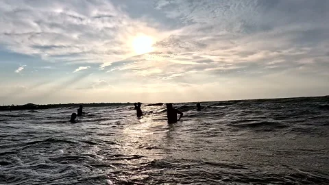 Las Penas, Ecuador: 3-11-2022: Silhouttes of people swimming in the ocean Video stock 336911140