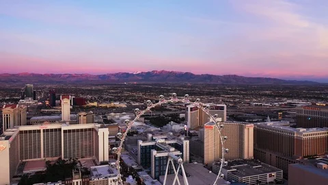 Las Vegas Strip at dawn - The Linq High Roller with mountains in background Stock Footage