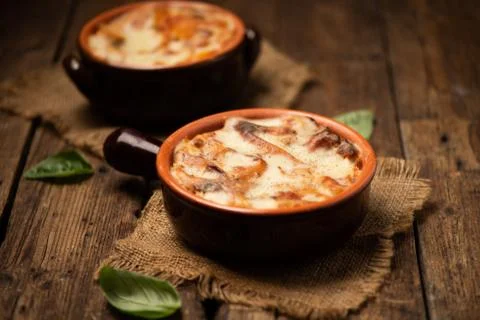 Lasagna dish on a rustic table. Food, mozzarella. Stock Photos