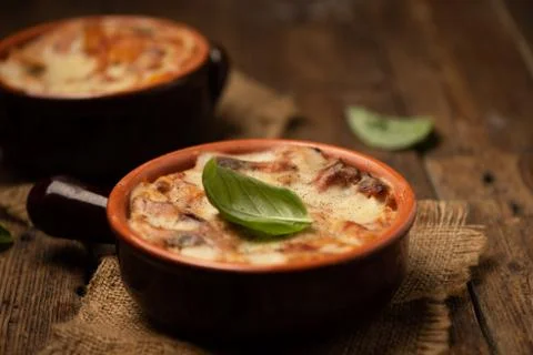 Lasagna dish on a rustic table. Food, mozzarella. Stock Photos