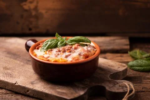 Lasagna dish on a rustic table Stock Photos