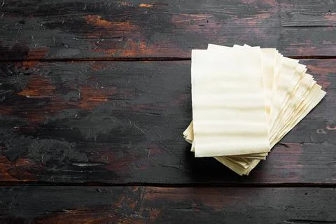 Lasagna dough sheets, on old dark wooden table background, with copy space fo Stock Photos