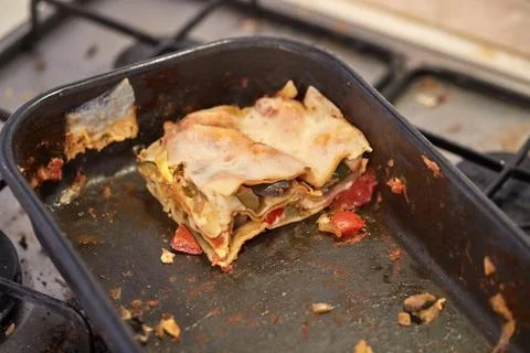 Lasagna leftover in a dirty kitchen Stock Photos