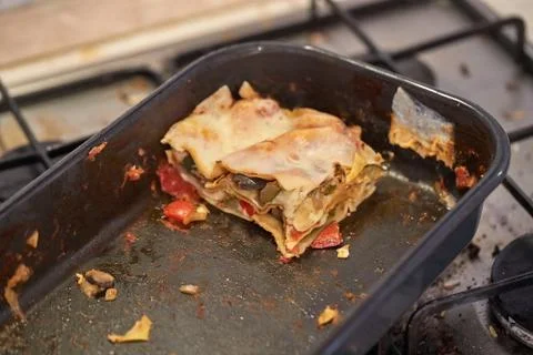 Lasagna leftover in a dirty kitchen Stock Photos