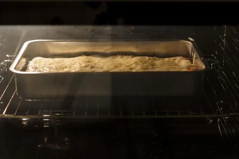 Lasagna in oven Stock Photos
