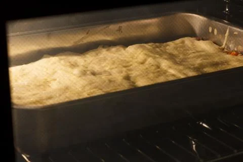 Lasagna in oven Stock Photos