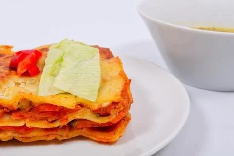 Lasagna with vegetables on a white Stock Photos