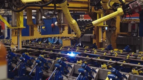 Laser automated machine weld the steel parts with bright blue sparkles flying Stock Footage 202049778