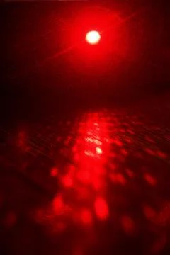 Laser beams of red on a dark background Stock Photos