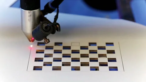 Laser cnc machine cutting square pattern on acryl plate Stock Footage 40524314