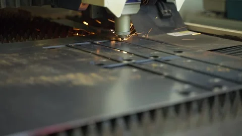 Laser cut head machine while cutting the sheet metal with the sparking light in Stock Footage 264579839