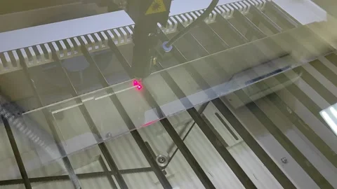 A laser cutter cuts a workpiece made of transparent plastic Stock-Footage 145806816