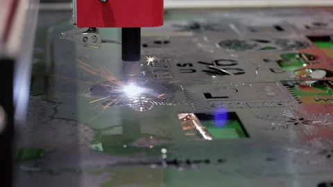 Laser cutting machine carves out element of metal sheet with bright sparks and Stock Footage 346611686