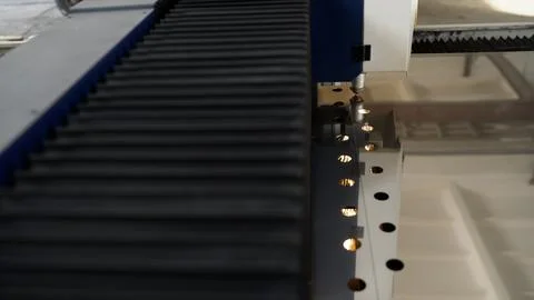 Laser cutting machine creating holes in metal sheet Stock Photos