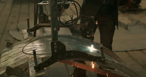 Laser cutting machine cutting through steel and piece falling close-up Stock Footage 129850313