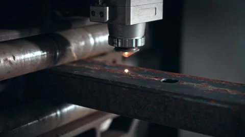 Laser cutting machine for metal. The coordinate machine cuts a rectangular pipe Stock Footage 297178310