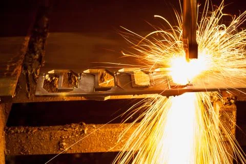 Laser cutting machine of metal sheet with sparks. Stock Photos