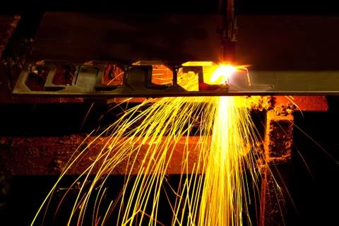 Laser cutting machine of metal sheet with sparks. Stock Photos