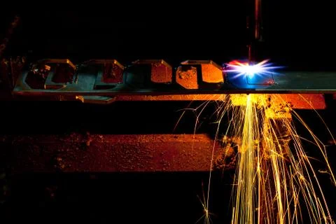 Laser cutting machine of metal sheet with sparks. Stock Photos