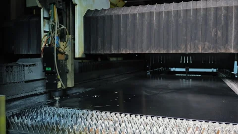 Laser cutting machine operating on black metal sheet in CNC fabrication system Stock Footage 309226565